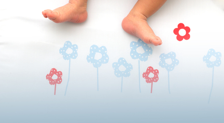 Baby feet.Children's feet on the floor sleeping pad.の写真素材