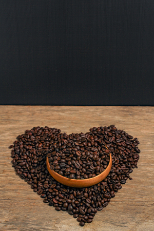 Coffee beans and wooden container with copy space.Heart shapeの写真素材