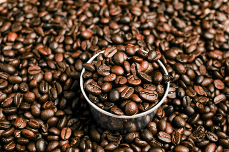 Coffee beans and stainless steel cup with copy space.の写真素材