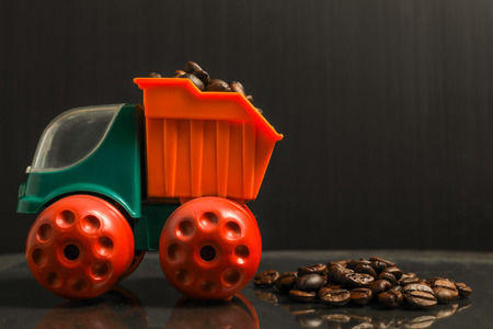 Roasted coffee beans and toy truck  with copy space.の写真素材