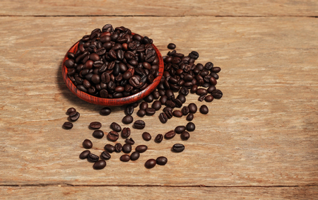 Roasted coffee beans and wooden container with copy space.Heart shapeの写真素材