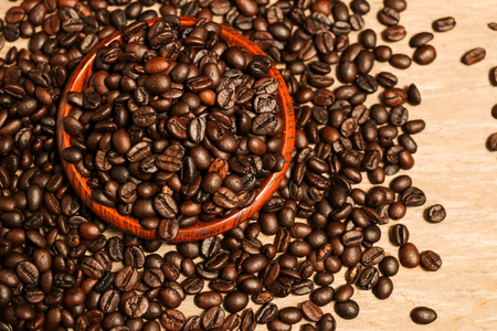 Roasted coffee beans and wooden container with copy space.Heart shapeの写真素材