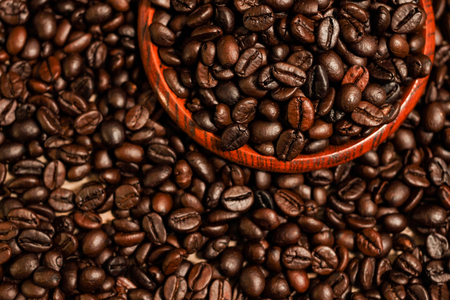 Roasted coffee beans and wooden container with copy space.Heart shapeの写真素材