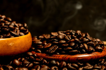 Roasted coffee beans and wooden container with copy space.Heart shapeの写真素材