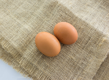 Chicken eggs on gunny sackの写真素材