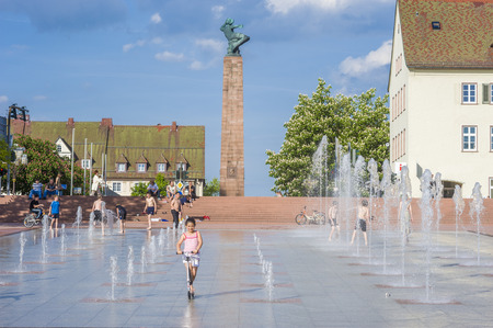 Playing children at the lower market place with fountains in Freudenstadt in the Black Forest, Baden-Wurttemberg, Germany, Europeのeditorial素材