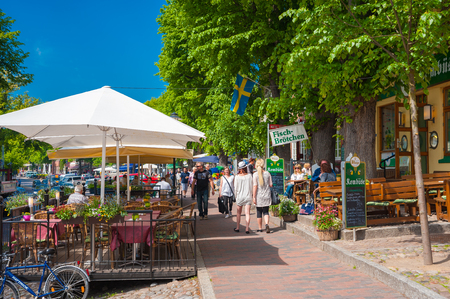 People dining at outside restaurant. The scene is Am Markt in Burg on the island Fehmarnのeditorial素材