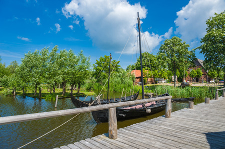 Viking ship and a slavic merchant-ship in the slavic village of the museum Wallmuseum in Oldenburg in Holsteinのeditorial素材