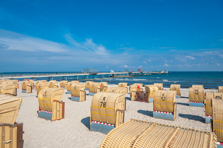 View about the beach with beach baskets toward the sea bridge in Kellenhusen on the Baltic Seaのeditorial素材