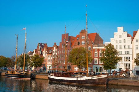 Historical cityscape with traditional sailing ships on the Untertrave river in L??¼beck at the...