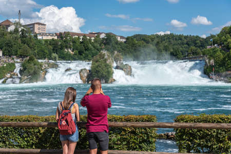 Tourists in front of the Rhine Falls in Neuhausen am Rheinfall. Canton Schaffhausen in Switzerlandのeditorial素材