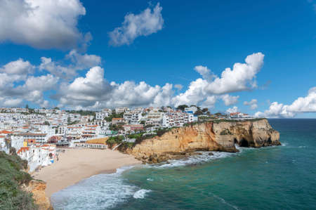 Cityscape of Carvoeiro in the Algarve in Portugal with beach and rocky coastの写真素材