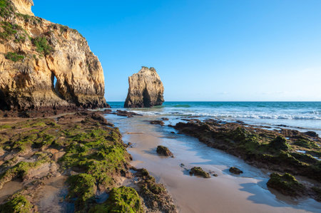 Praia dos Tres Irmaos, rocky landscape on the beach of Alvor in the Algarve in Portugalの写真素材