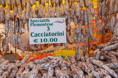 Market stall at the weekly market of Cannobio with Italian salami specialties. Cannobio is a town on Lake Maggiore in the Piedmont region of northern Italyの写真素材