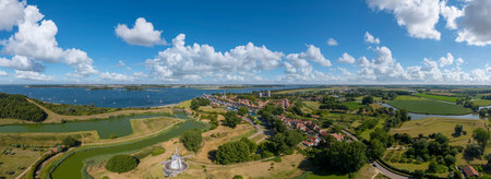 Aerial view over Veere with the historic town hall and the Great Church. In the background the Veerse Meer. Veere is a city in the province of Zeeland in the Netherlandsの写真素材