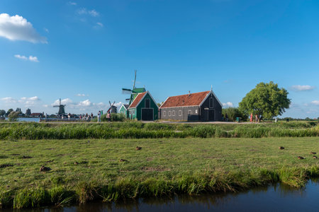Zaandam, Netherlands - August 07, 2022: Rural scene with historical windmills in the Zaanse Schans open-air museum in Zaandam. Province of North Holland in the Netherlandsのeditorial素材