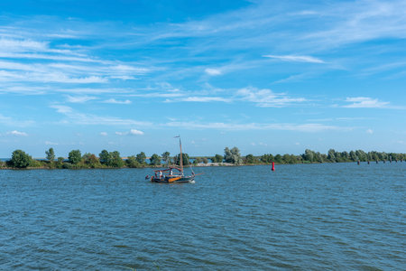 Enkhuizen, Netherlands - August 03, 2022: Landscape with a sailing boat on the IJsselmeer. Enkhuizen in the Province of North Holland in the Netherlandsのeditorial素材
