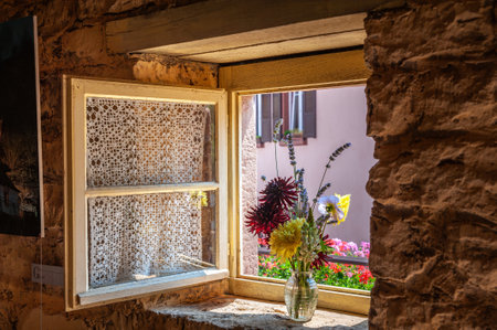 Eschbourg, France - July 27, 2021: Window of historic rock dwellings, Maison des Rochers, in Graufthal. Bas-Rhin department in the Alsace region of Franceのeditorial素材