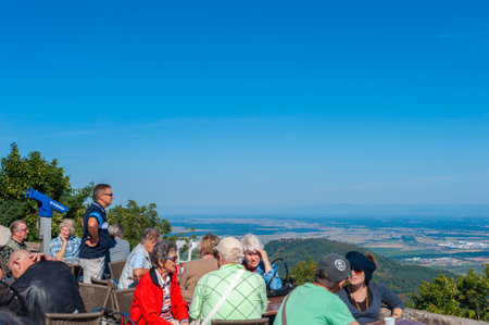 Orschwiller, France - September 16, 2021: Tourists at viewpoint in front of ChÃ¢teau du Haut Koenigsbourg near Orschwiller. In background Upper Rhine Plain and hilly landscape of Black Forest. Bas-Rhin department in region in Franceのeditorial素材