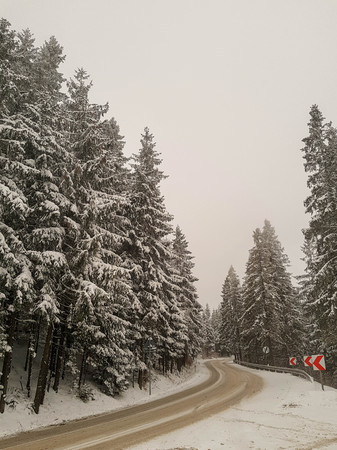 Curvy Snowy Country Road in Polish mountains, Poland, Europeの写真素材