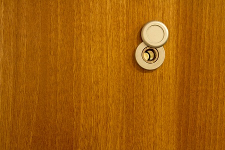 Door lens in the wooden backgroundの写真素材
