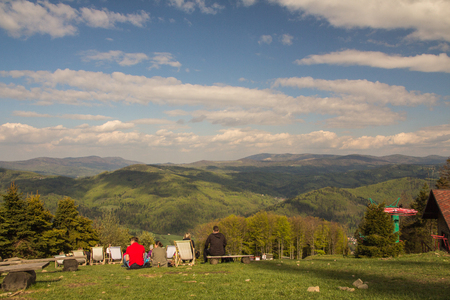 People chilling out on the sunbeds on the top of the mountain, Czantoria, Polandの写真素材