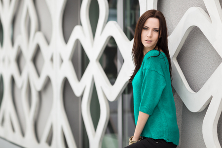 Young Woman posing near the modern buildingの写真素材