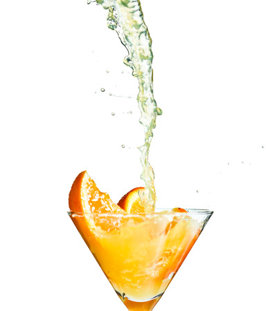 Splashing orange juice isolated on whiteの写真素材