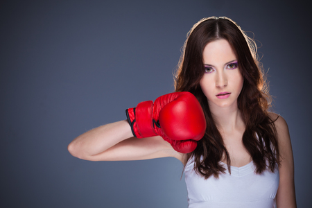 Beautiful young girl with boxing glovesの写真素材