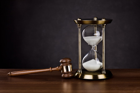 Gavel and Hourglass on darkの写真素材