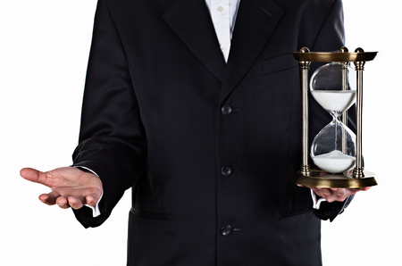Businessman with hourglass in hand isolated on white