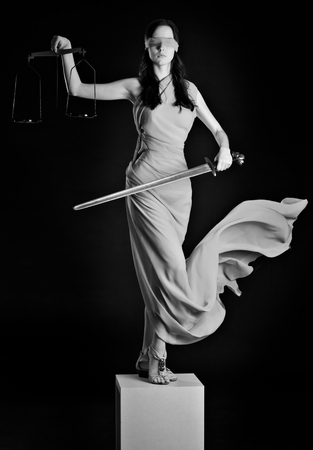 Statue of justice. Blind Woman with scale and sword.の写真素材