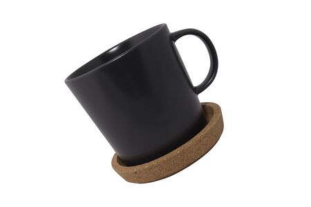 black cup of coffee and round Cork mat with brown border isolated on white backgroundの写真素材