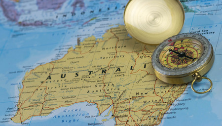 Compass on a close up map pointing at Australia and planning a travel destination.のeditorial素材