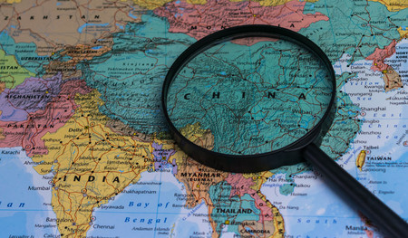 Map of china through magnifying glass on a world map.の写真素材
