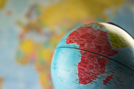 Africa map on a globe with earth map in the background.の写真素材