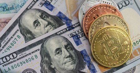 Bitcoins with US banknotes and british banknotes, 20 pounds sterling, 10 pound sterling notes....