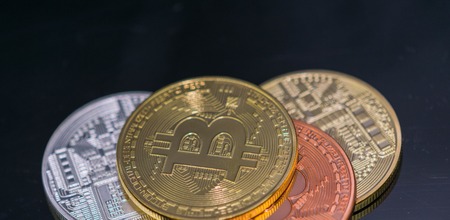 Golden Bitcoin Coin close up together with silver bitcoin and bronze bitcoin ,close-up view.の写真素材