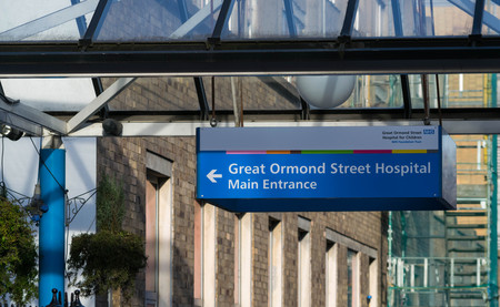London, United Kingdom, February 17, 2018 : The front entrance of Great Ormond Street Hospital for Children in Bloomsbury with an information sign in the foregroundのeditorial素材