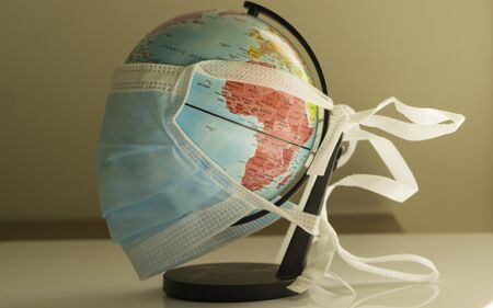 World globe wearing surgical mask to fight corona virus covid 19 pandemicの写真素材
