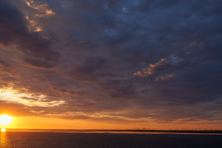Sunset over the sea with dramatic clouds