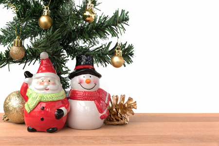 Santa claus and snowman with the christmas tree and golden decoration, this is season greeting for joyful and happinessの写真素材