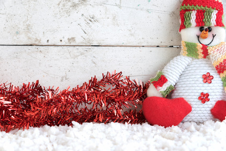 snowman sitting on snow with streamer in vintage backgroundの写真素材
