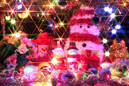 santa claus and snowman with a decorated christmas tree with light, santa claus is coming in town, closeupの写真素材