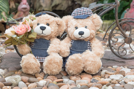 two teddy bears with roses on garden background, love concept for valentines day, wedding and anniversaryの写真素材