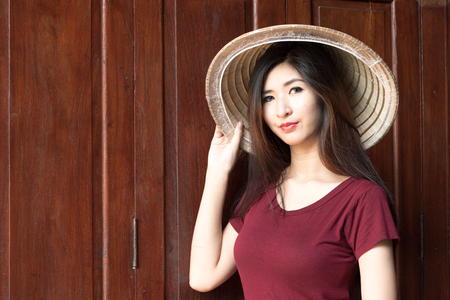A portrait of beautiful asian woman with wooden backgroundの写真素材
