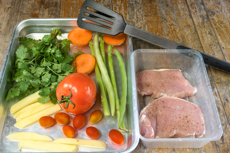 prepare ingredients for cooking on wooden table, vegetables and porkの写真素材