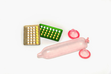 condom and birth control pills on white background, contraception and birth control, contraceptives conceptの写真素材