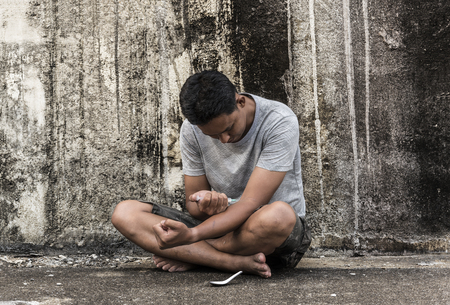 asain male drugs narcotic syringe in action, addiction conceptの写真素材