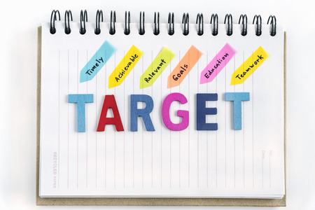 Words target on the notebook with handwriting timely achievable relevant goals education teamwork...